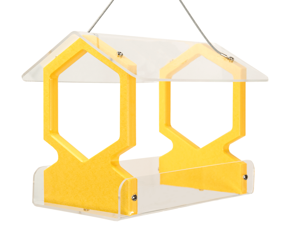 Acrylic and plastic bird feeder with yellow hexagon accents and a clear roof showing a modern design suitable for outdoor use.