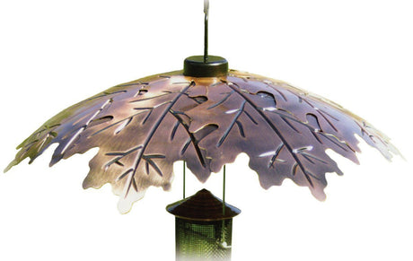Metal bird feeder with copper leaf design showing detailed veining and a dark brown central section hanging from a black hook adding a touch of autumn to any garden