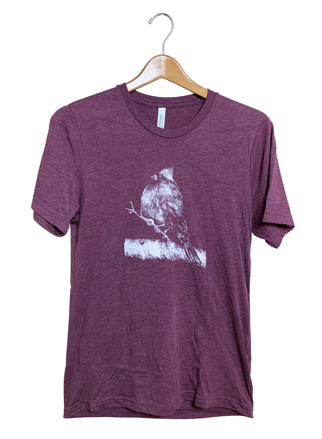 Canvas Bella t-shirt featuring a white ink drawing of a cardinal perched on a branch with textured details and subtle shading against a maroon heather background