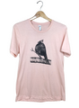 Screen print on peach-colored t-shirt depicting a Northern Cardinal perched on a branch with detailed shading and textured bark.