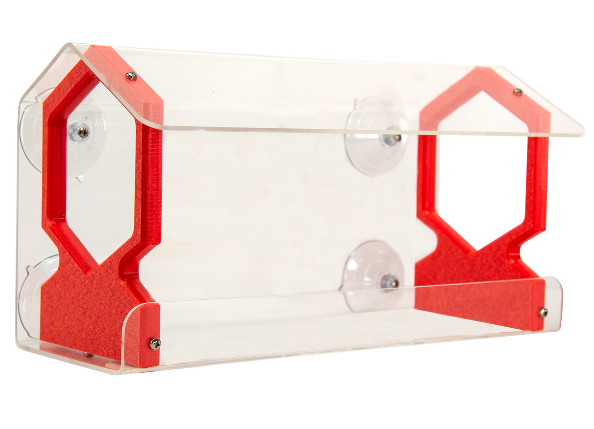Acrylic bird feeder with red accents featuring suction cups and hexagonal details showcasing a clear tray and house-shaped design
