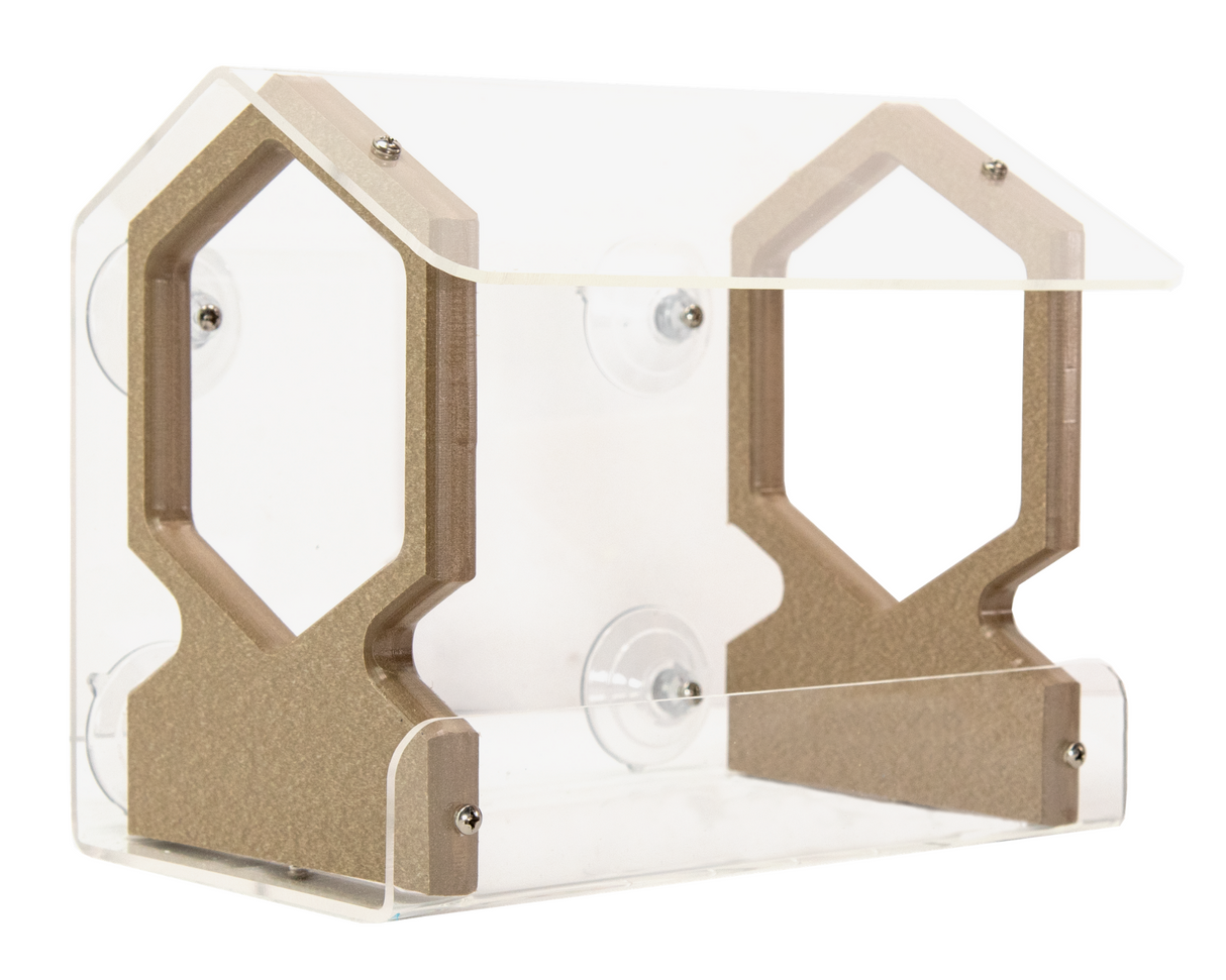 Acrylic and wood bird feeder with a house-shaped design featuring hexagonal cutouts, clear acrylic walls, and suction cups for easy window attachment.