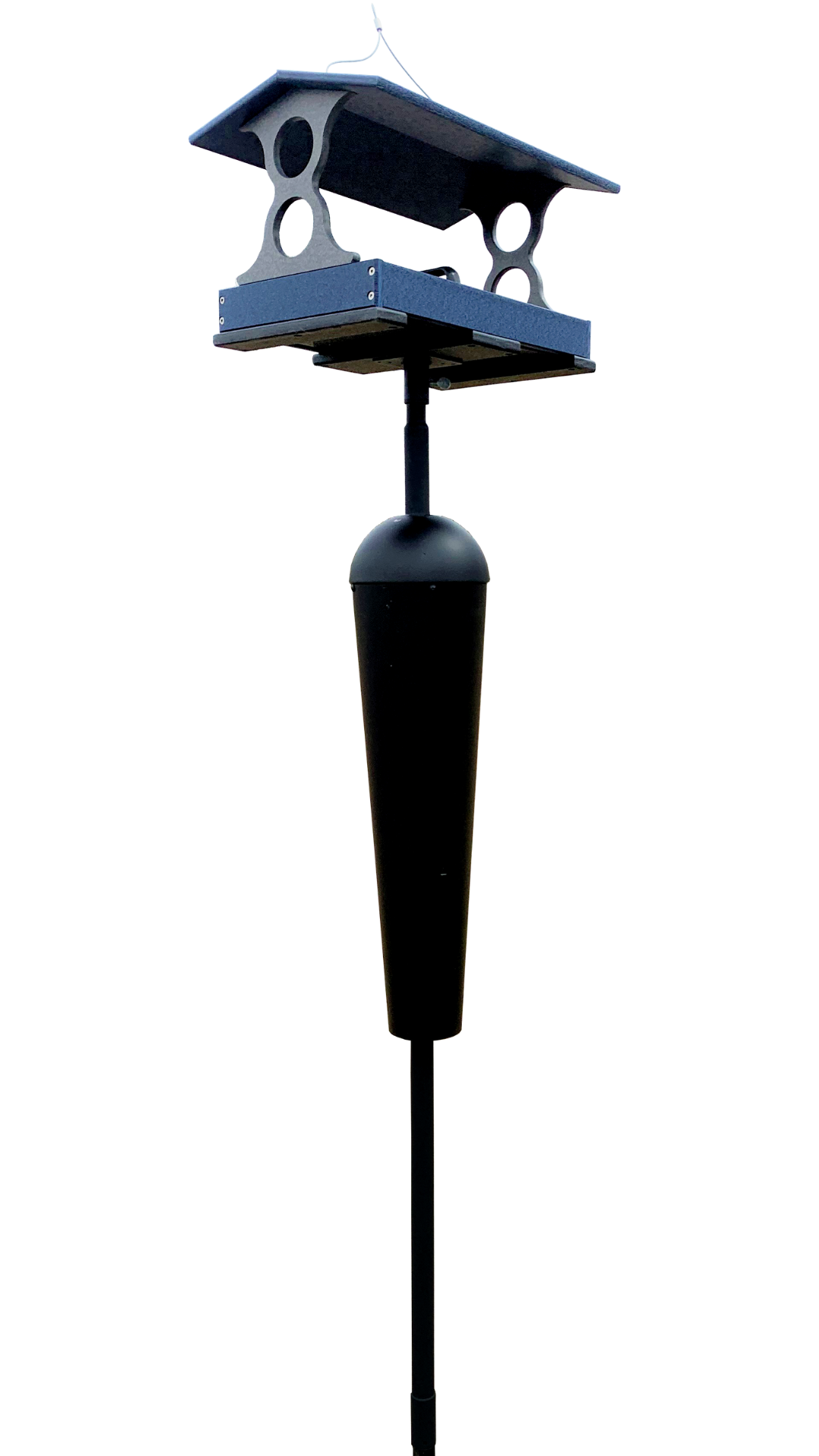 Photograph of a blue and gray recycled plastic bird feeder with a black pole and a conical bottom reservoir featuring a dark gray roof and circular cutouts for birds to access the seed tray