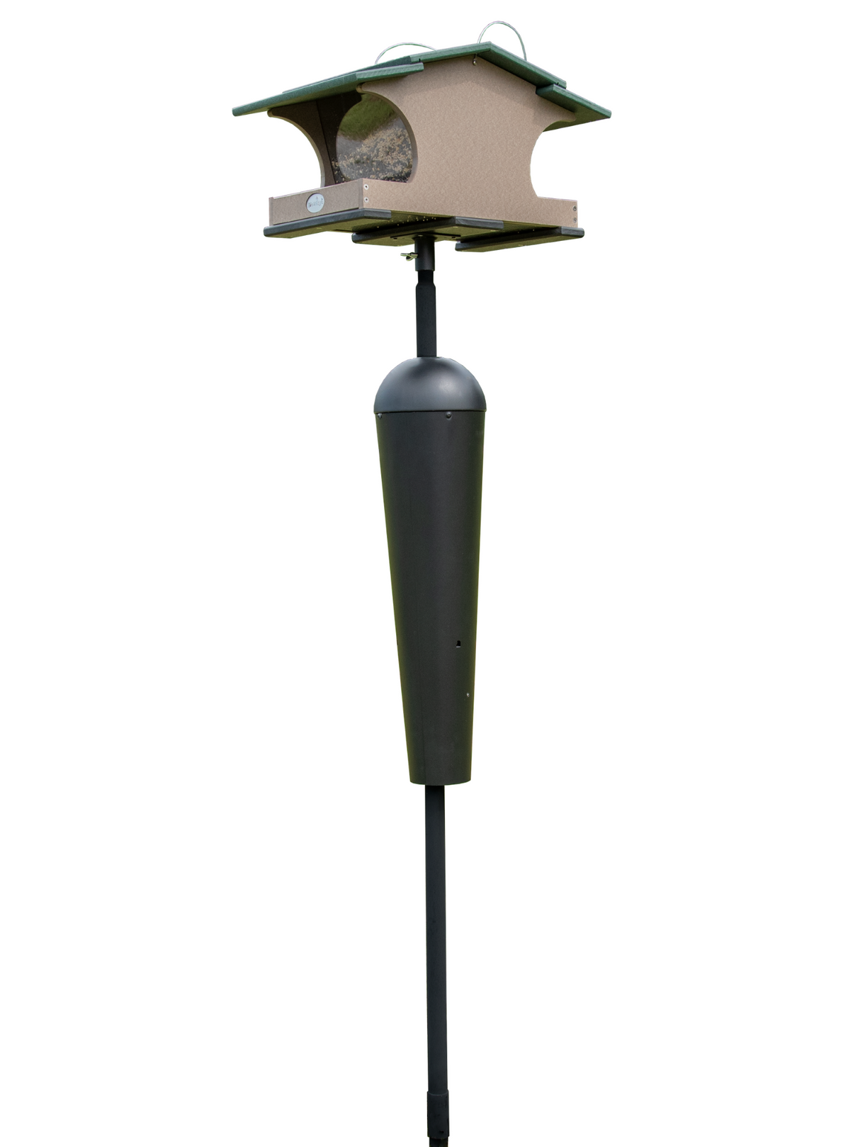 Product shot of a beige and green plastic bird feeder with a black squirrel baffle on a tall pole against a white background showing seed inside the feeder and a dark green roof
