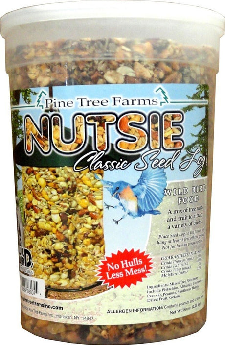 Pine Tree Farms Nutsie Classic Seed Log packaging shows a colorful mix of nuts, seeds, and dried fruit with a vibrant bluebird illustration and the brand logo.
