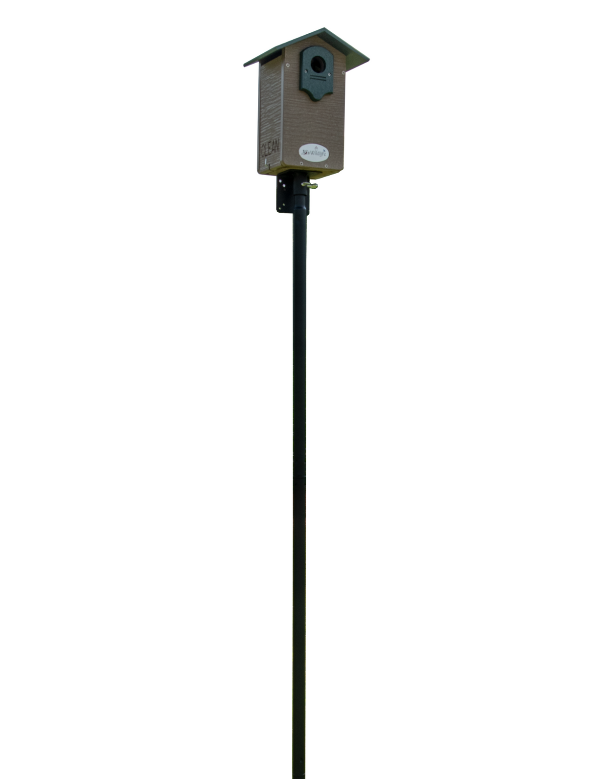 A photograph shows a Jo Wildridge birdhouse on a tall black post against a white background the house is brown with a green roof and features the word CLEAN and a small circular opening for birds