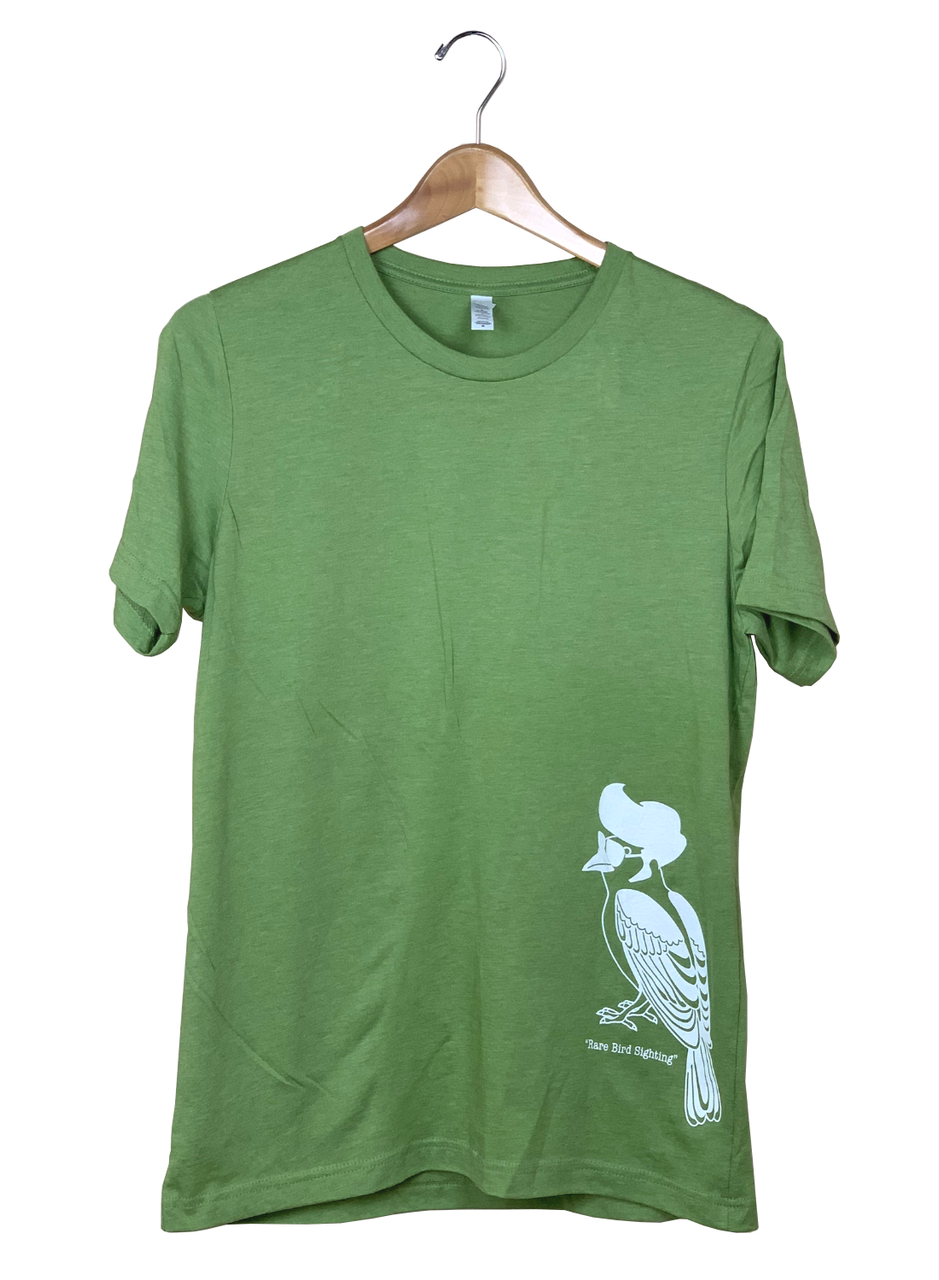 Green cotton t-shirt featuring a white illustration of a bird wearing sunglasses and a pompadour on a hanger  the bird has stylish lines and the shirt is a unique olive green color