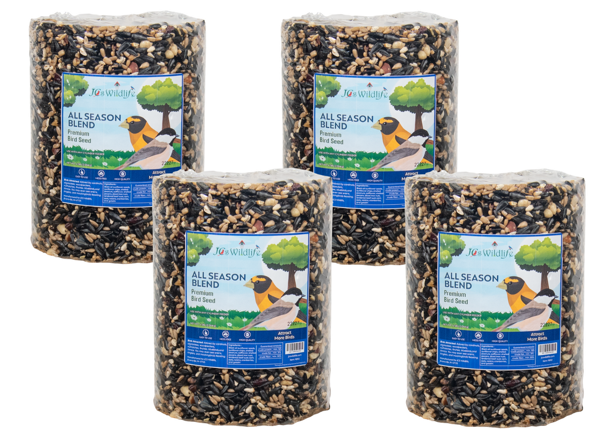 JCs Wildlife product photography showing four cylindrical packages of All Season Blend premium bird seed featuring sunflower seeds, peanuts, and dried cranberries against a white background.