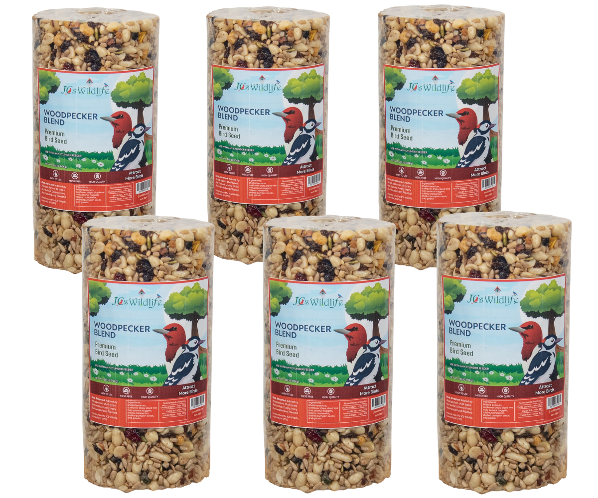 Product photography showing six cylindrical packages of Jos Wildlife Woodpecker Blend premium bird seed featuring peanuts, sunflower seeds, and dried cranberries against a white background