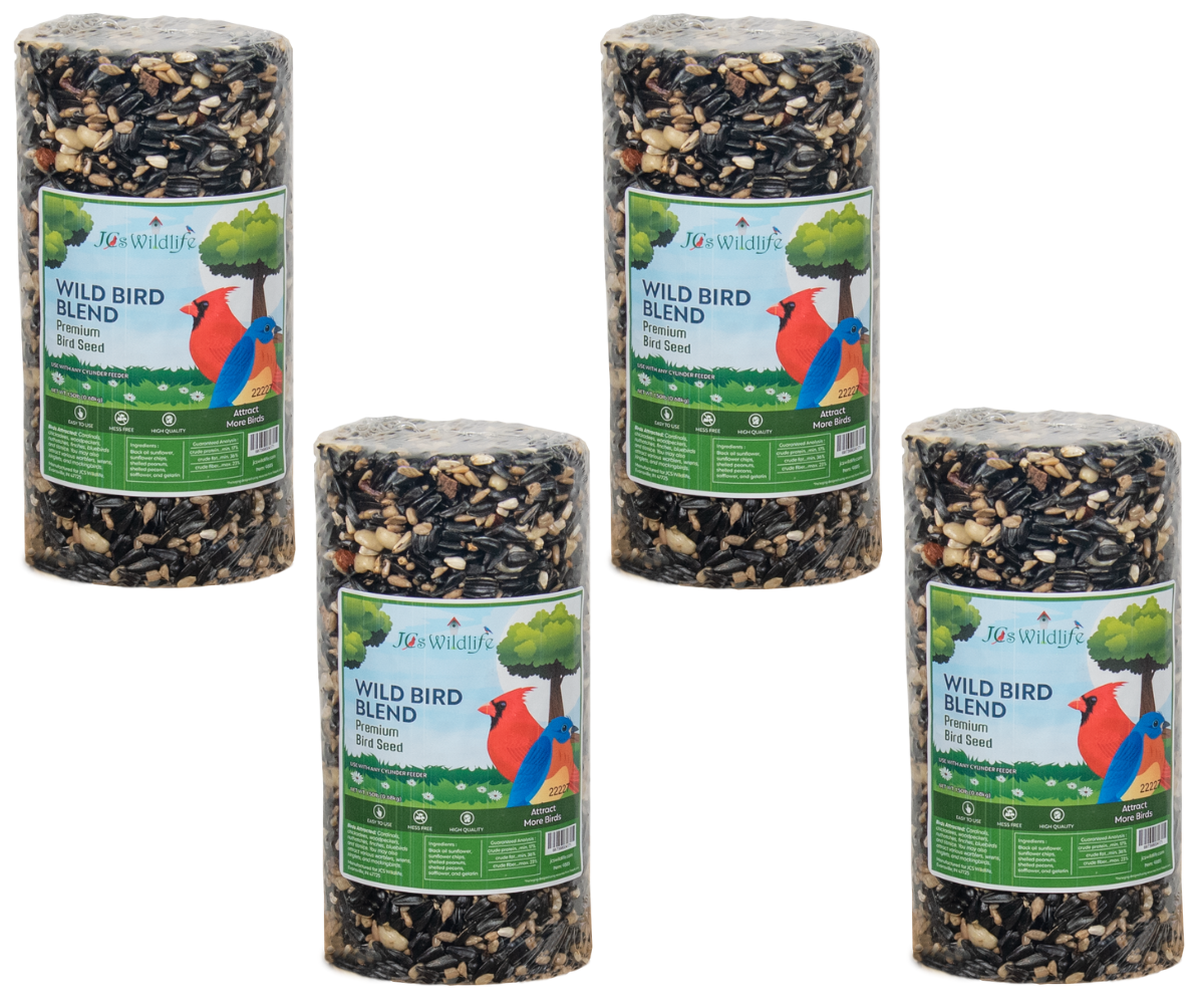 Product shot showing four cylindrical packages of Jos Wildlife Premium Wild Bird Blend seed featuring a cardinal and bluebird on the label against a white background, showcasing various seeds like sunflower, peanuts, and cracked corn