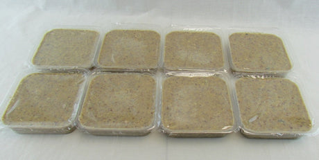 Photograph eight portions of  a muted olive-green paste in clear plastic containers showing a slightly mottled texture and subtle speckles throughout.