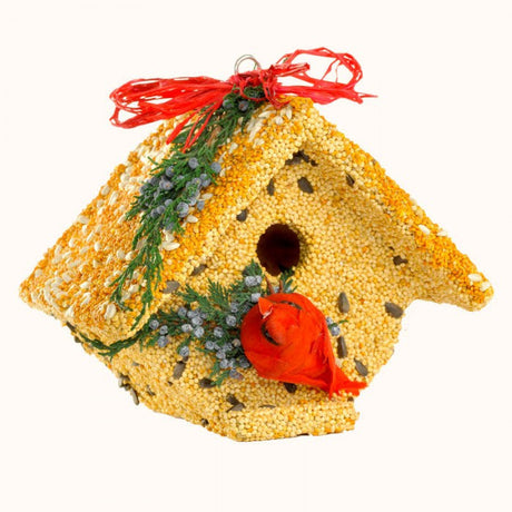 Artisan birdhouse crafted from birdseed featuring a vibrant red cardinal a red ribbon and cedar sprigs