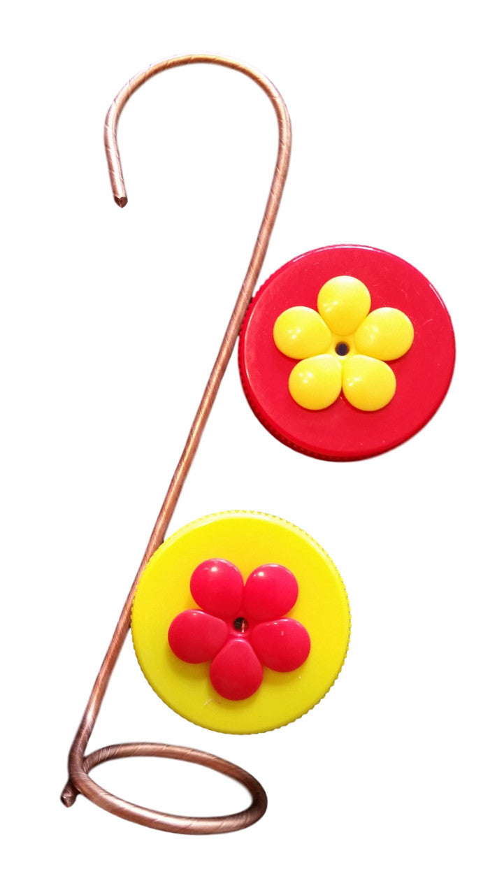 Unknown artist's mixed media sculpture featuring two vibrant circular elements with contrasting red and yellow flower appliqués affixed to a copper wire stand
