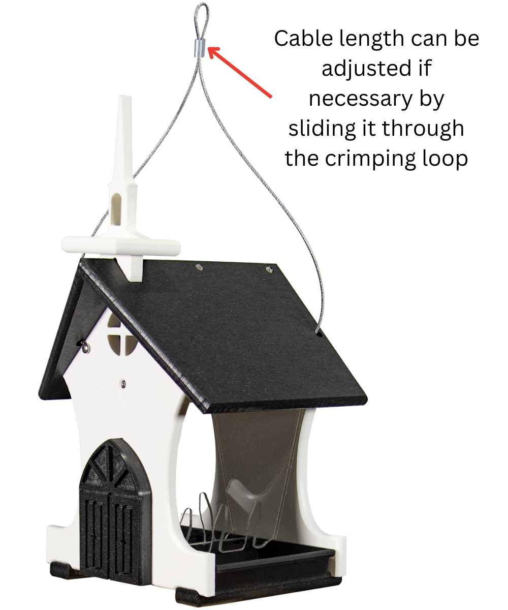Plastic birdhouse feeder shaped like a church with a black roof white walls and a small cross featuring a wire hanger and clear plastic feeding tray