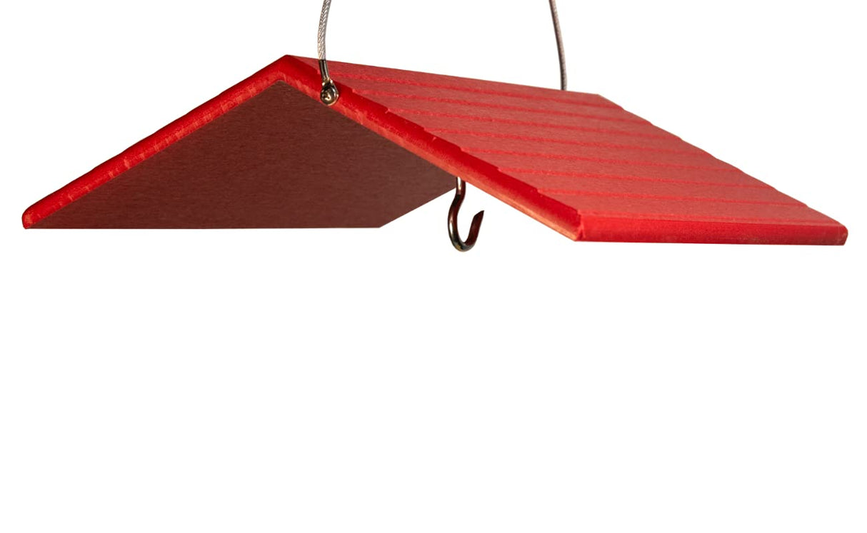 Red wood bird feeder hanging from wire featuring a  ridged roofline a metal hook and vibrant red color
