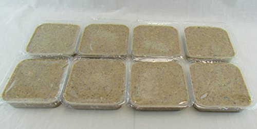 Photograph of eight square containers of tan-colored, possibly homemade, pet food showing a slightly textured surface and sealed with clear plastic wrap