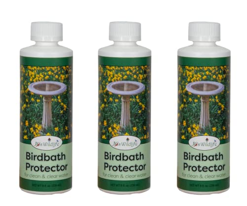 Product shot showing three bottles of J&S Wildlife Birdbath Protector featuring a classic pedestal birdbath surrounded by vibrant yellow flowers and lush green grass in a garden setting