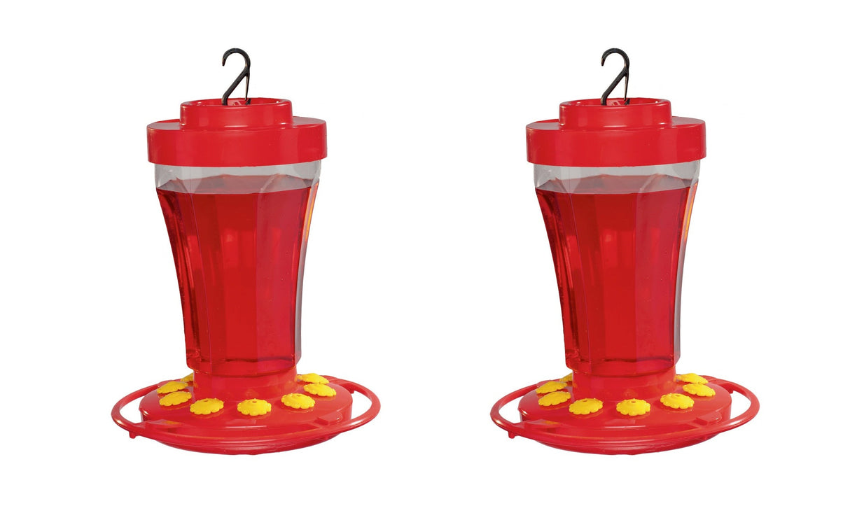Product shot two red plastic hummingbird feeders with clear reservoirs and yellow perches against a white background