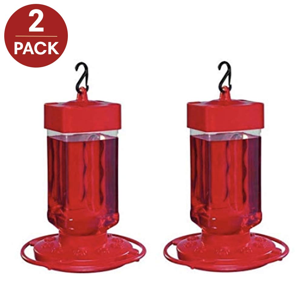 Product photo two red plastic hummingbird feeders with clear reservoirs and black hanging hooks filled with red nectar showing wavy liquid inside