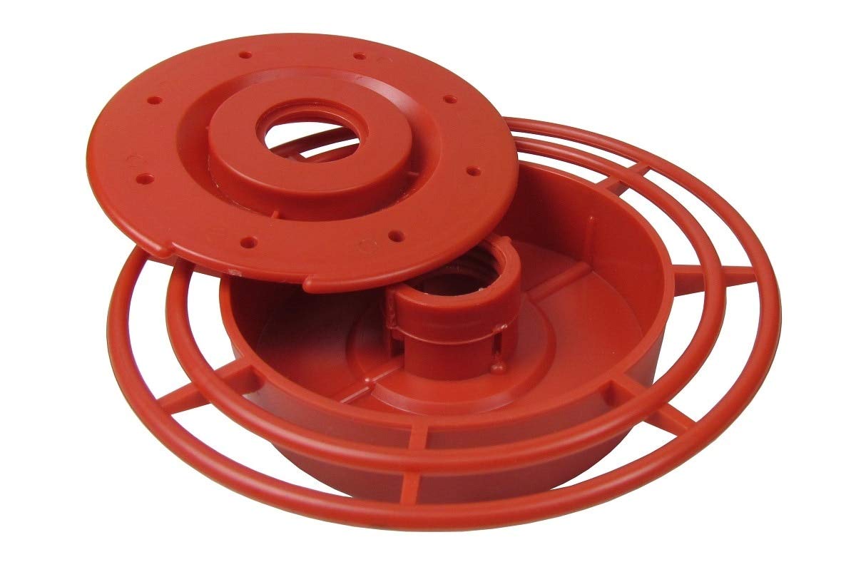 Plastic hummingbird feeder disassembled showing a bright red base, a removable top with small holes, and a circular perch with a central feeding tube