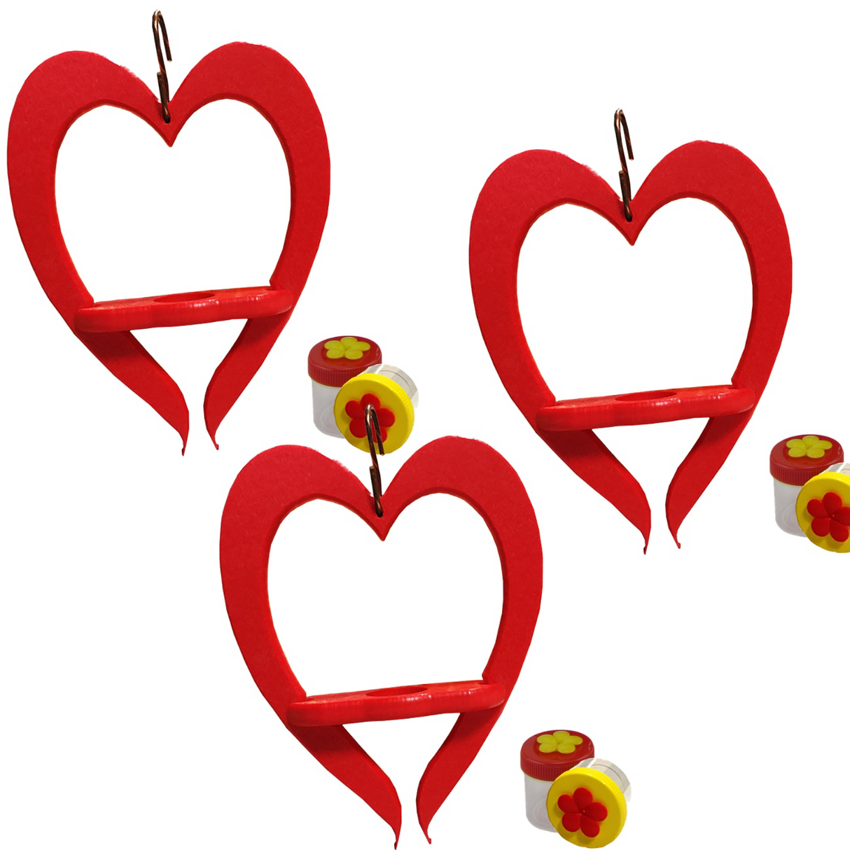Three handcrafted red heart-shaped bird feeders with small yellow flower-topped containers against a white background