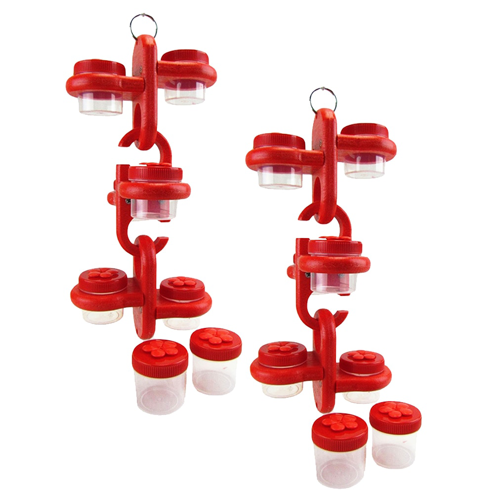 Product shot showing two red plastic hummingbird feeders with clear jars and flower-shaped lids against a white background
