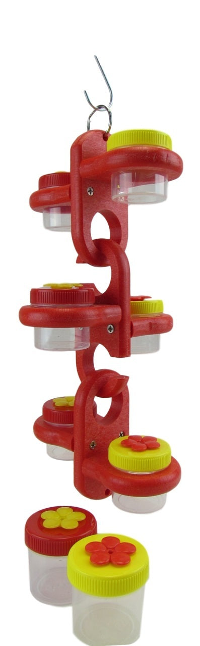 Plastic bird feeder with red and yellow flower-shaped jar lids showing multiple small clear jars hanging from a metal hook