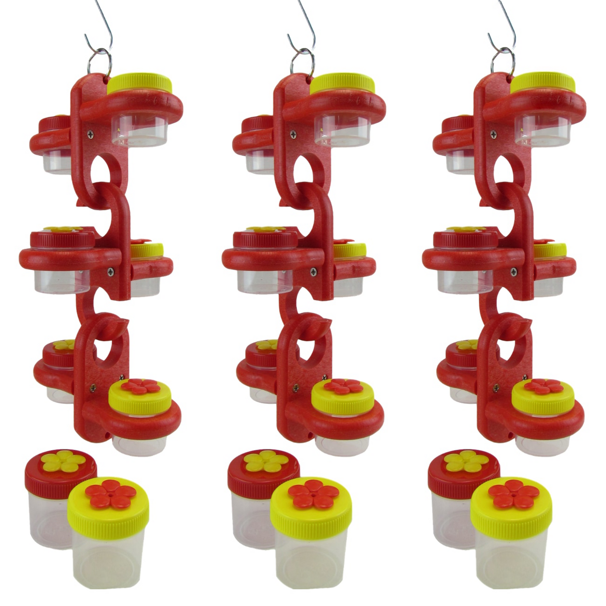 Product shot showing three red plastic hummingbird feeders with clear jars and yellow and red flower-shaped lids against a white background