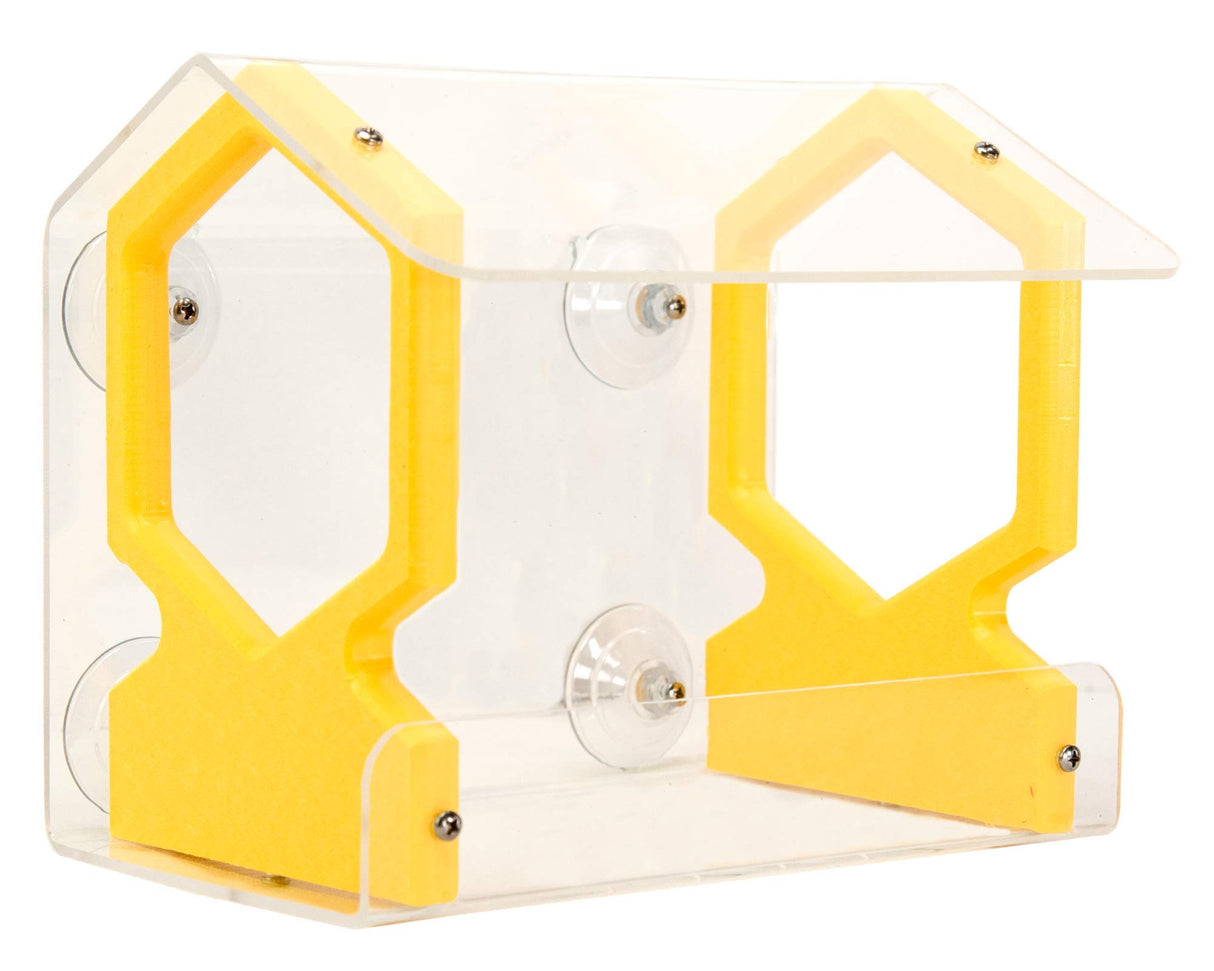 Acrylic bird feeder with yellow accents and suction cups attached to a window showing clear acrylic and small screws