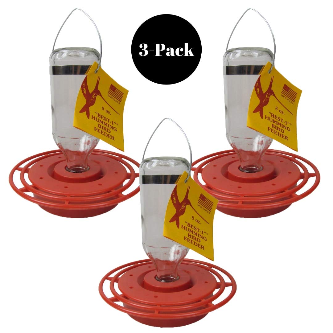 Product shot showing three Best-1 8 oz hummingbird feeders with red plastic bases and clear glass bottles featuring yellow and red labels against a white background