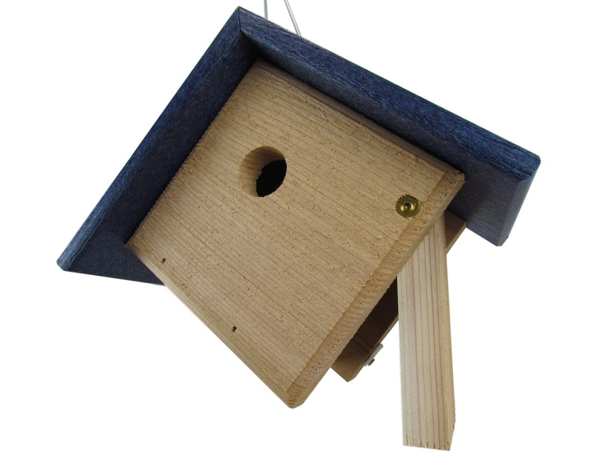 Wooden birdhouse with a dark blue roof a small entry hole and light wood body showcasing brass colored screws and drainage holes