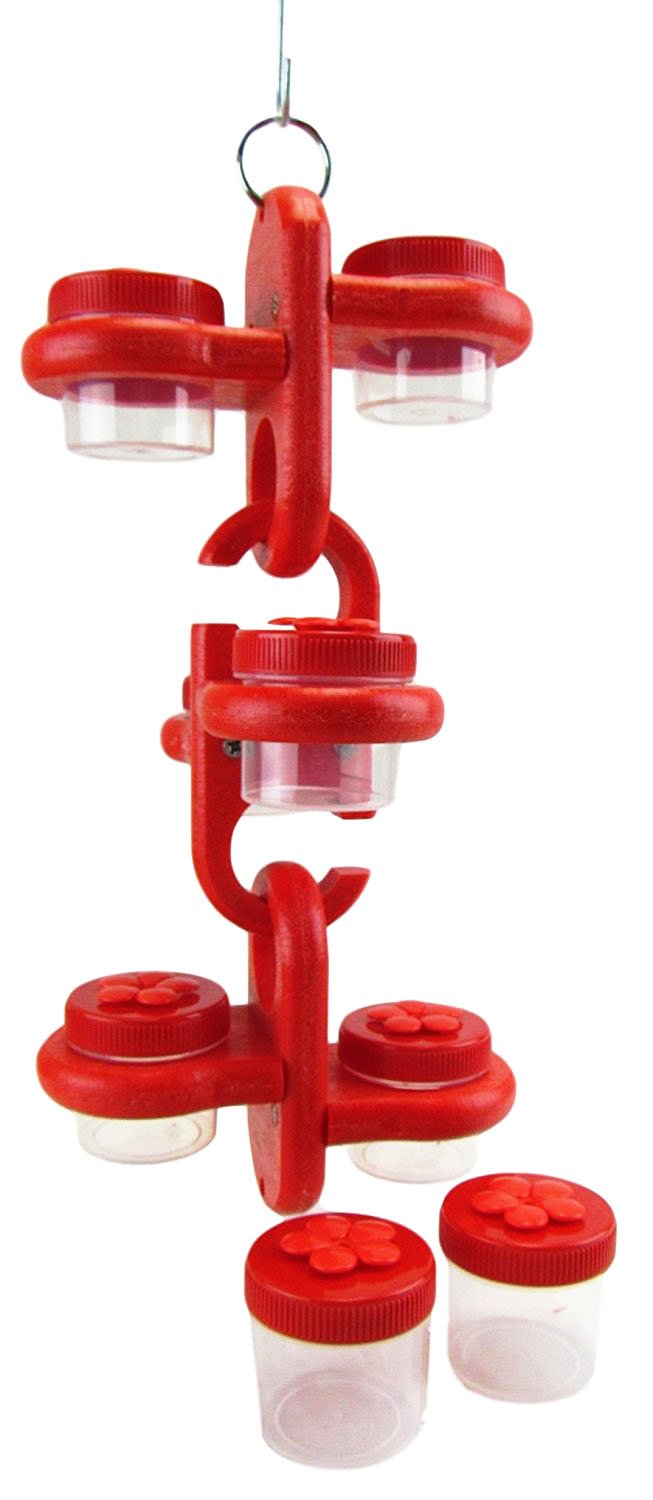 Plastic hummingbird feeder with six clear jars and bright red lids showing flower-shaped details hanging from a metal ring