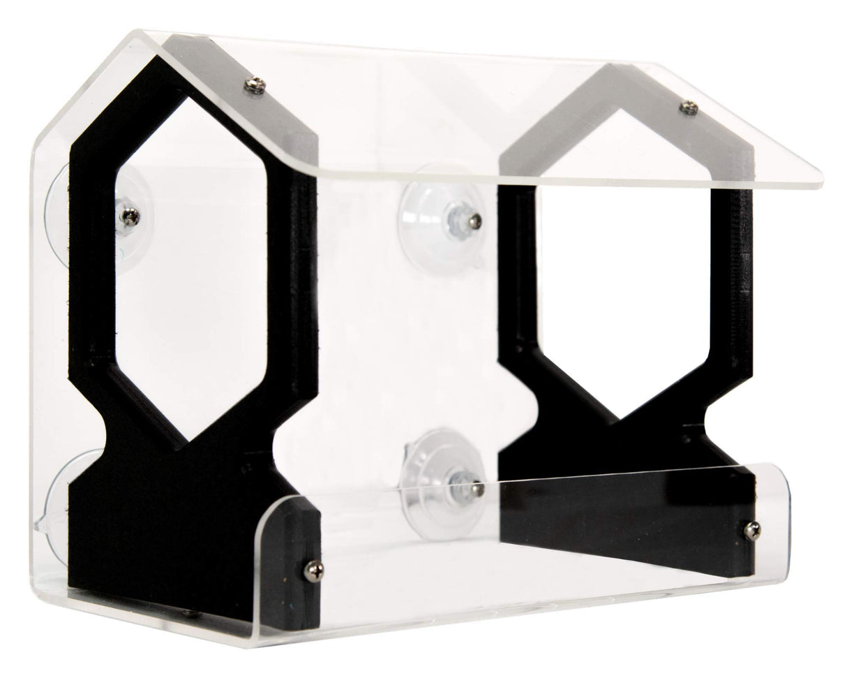 Acrylic bird feeder with black accents and suction cups attached to a window showcasing its transparent design and geometric hexagonal shapes.