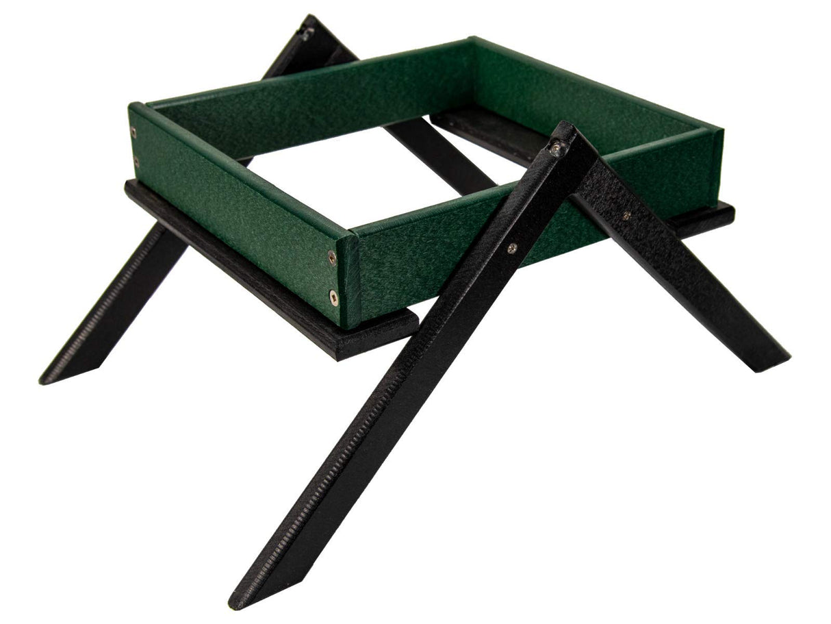 Product photography showing a dark green recycled plastic tray with black legs featuring visible screw details and a textured surface
