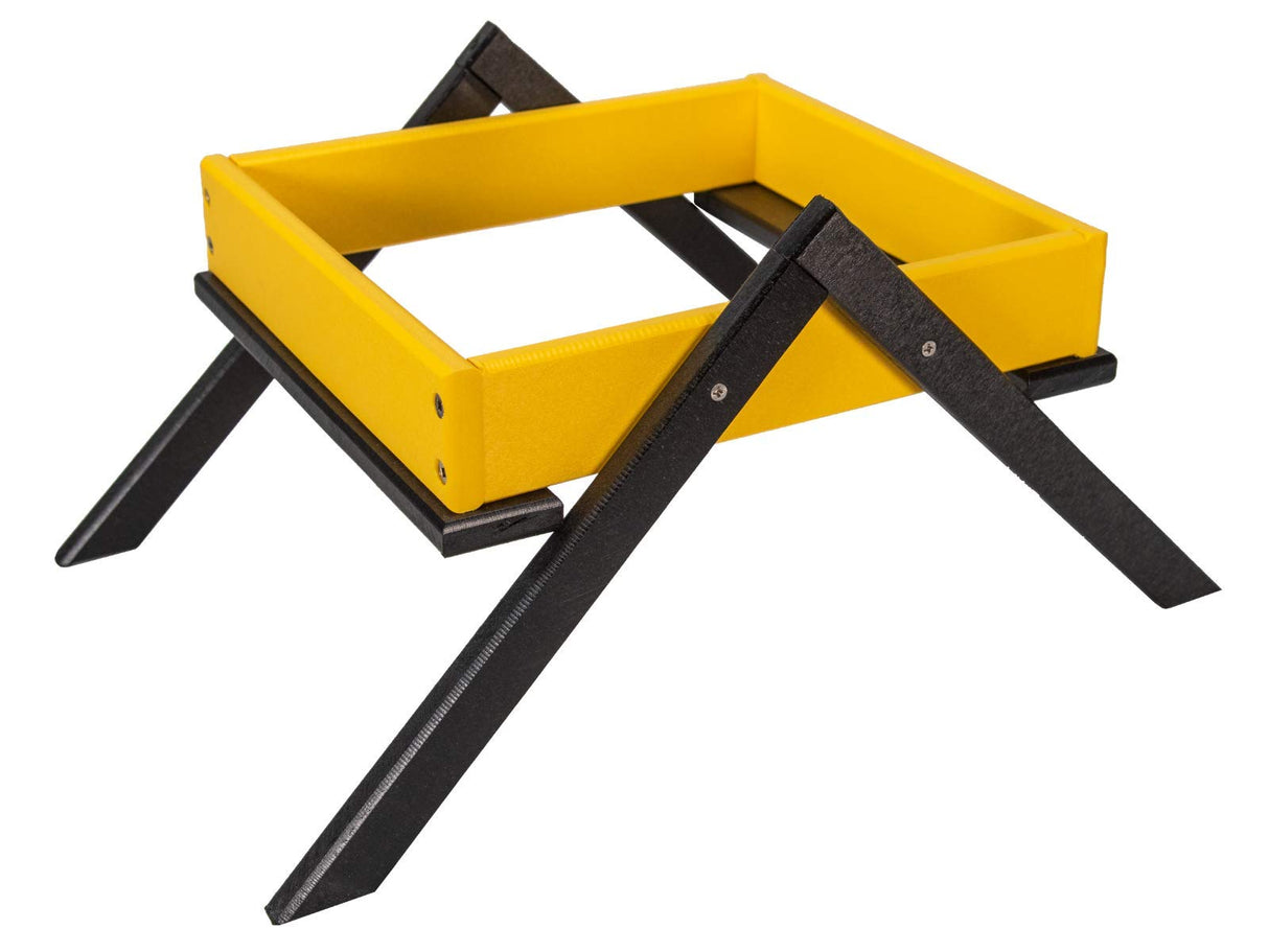 Product photography of a yellow and black plastic tray stand with visible screw details and a sturdy X-shaped base.