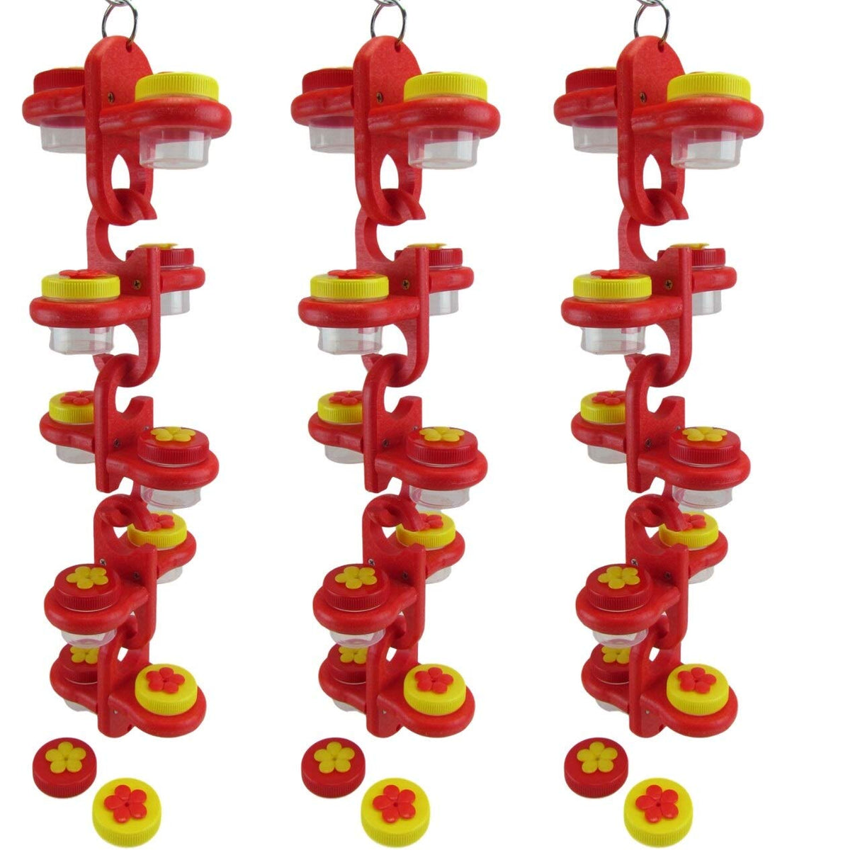 Product shot showing three red plastic hummingbird feeders with yellow and red flower-shaped lids clear containers and hanging rings against a white background