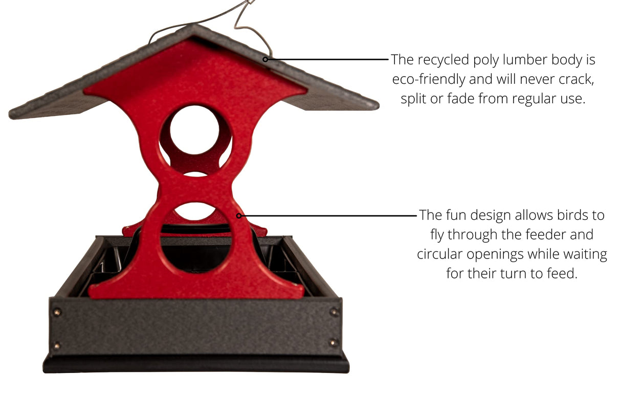 Product shot of a red and gray recycled poly lumber bird feeder with a pitched roof and multiple circular openings for birds to feed from