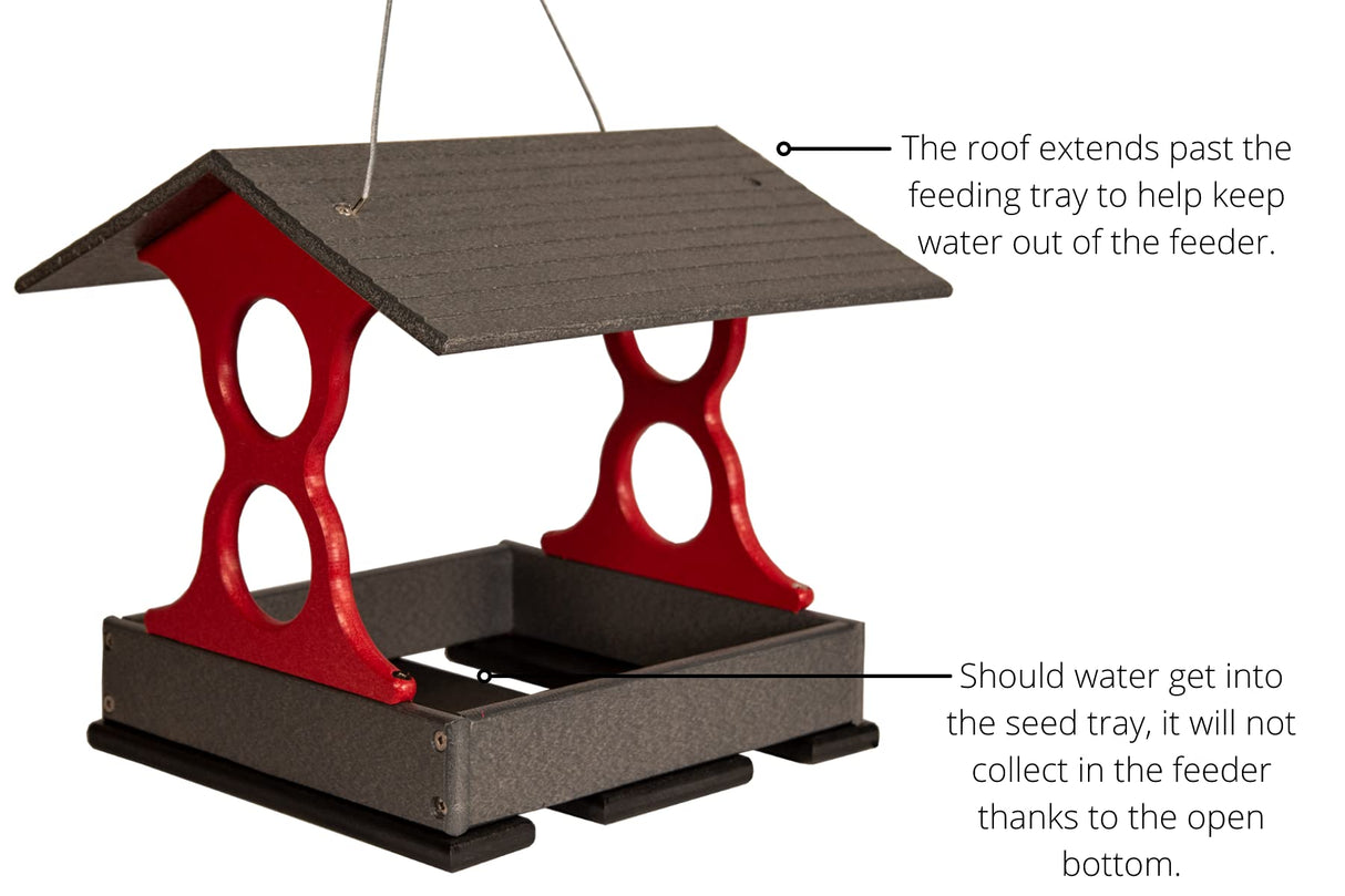 Plastic bird feeder with gray roof and vibrant red accents showing a hanging design and open bottom for drainage
