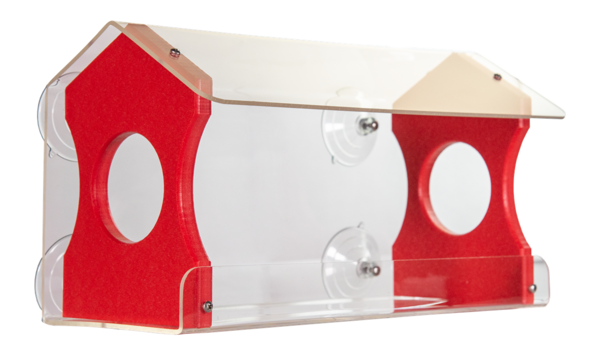Acrylic bird feeder with red accents and clear panels showing two feeding areas attached by suction cups to a window showcasing a beige roof