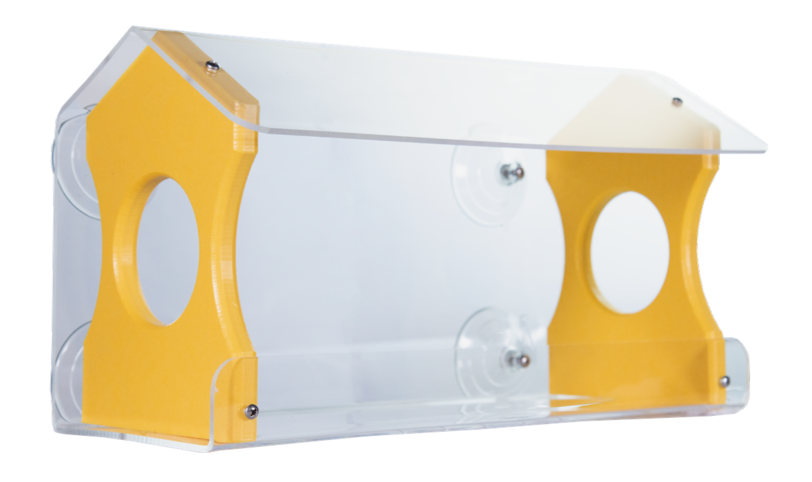 Acrylic bird feeder with yellow wooden accents and clear protective roof showing suction cups and two circular openings for birds to access food