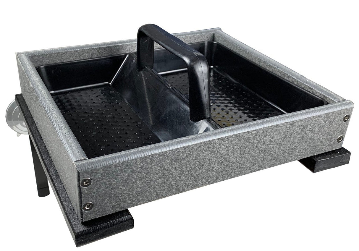 Product photography showing a gray plastic bird feeder with a black removable tray textured bottom and a black handle