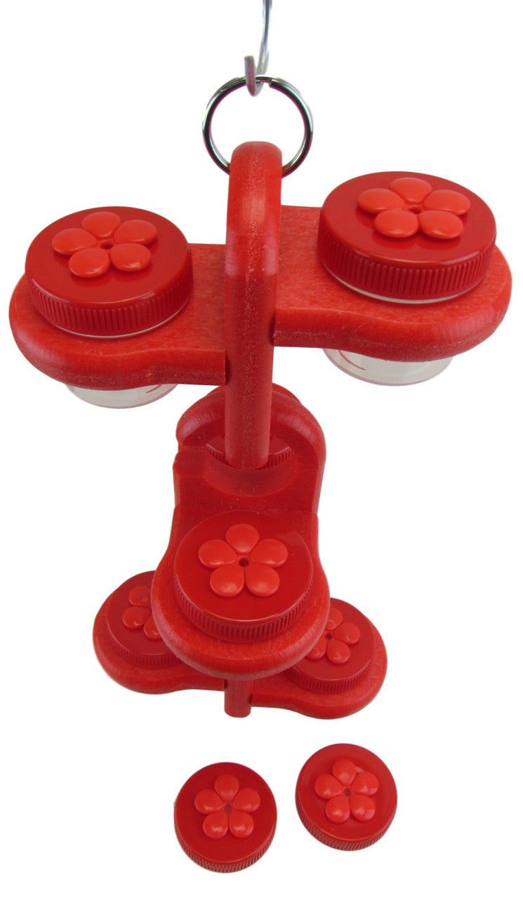 Plastic bird feeder with three red jars featuring flower-shaped lids a hanging ring and a bright red textured base