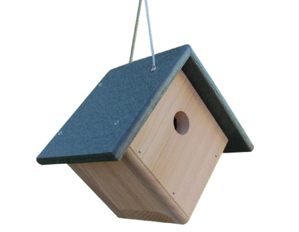 Wooden birdhouse with a dark green roof hanging against a white background featuring a circular entrance hole and visible screws and a hanging string.