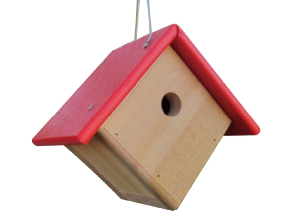 Wooden birdhouse with bright red roof and small entrance hole hanging against a white background