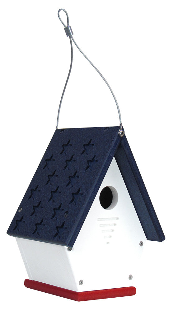 Recycled plastic birdhouse with a navy blue roof featuring embossed stars a white body and a red base hanging from a wire