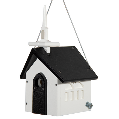 Plastic birdhouse by unknown artist shaped like a church with a white steeple black roof and tiny arched windows showing a charming whimsical design