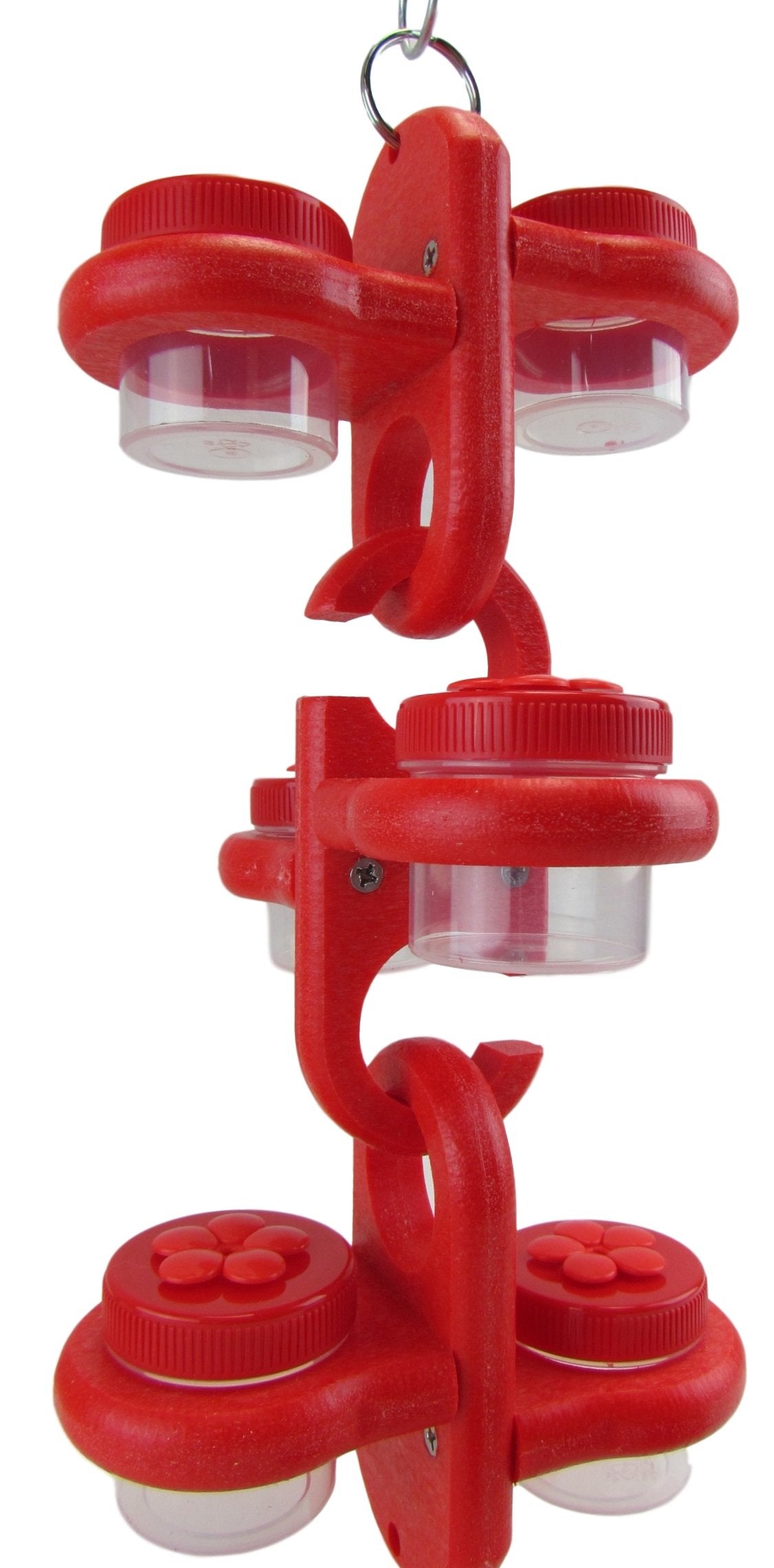 Plastic bird feeder with six clear jars and bright red lids, featuring flower-shaped accents and a textured surface, hanging from a metal ring.