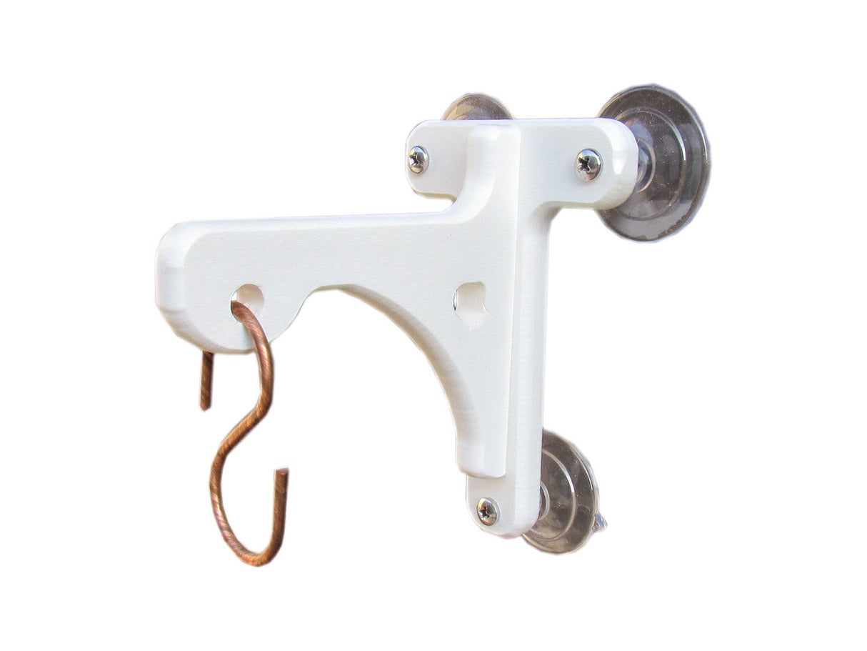 Product shot of a white plastic window mount with suction cups and a copper hook showcasing its sturdy design and simple elegance