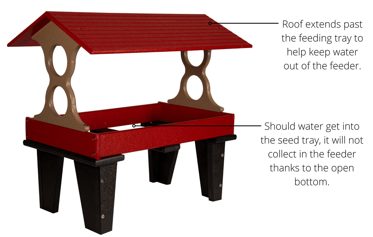 Plastic recycled bird feeder with red tray, taupe supports, and black legs showing a sloped roof and open bottom design