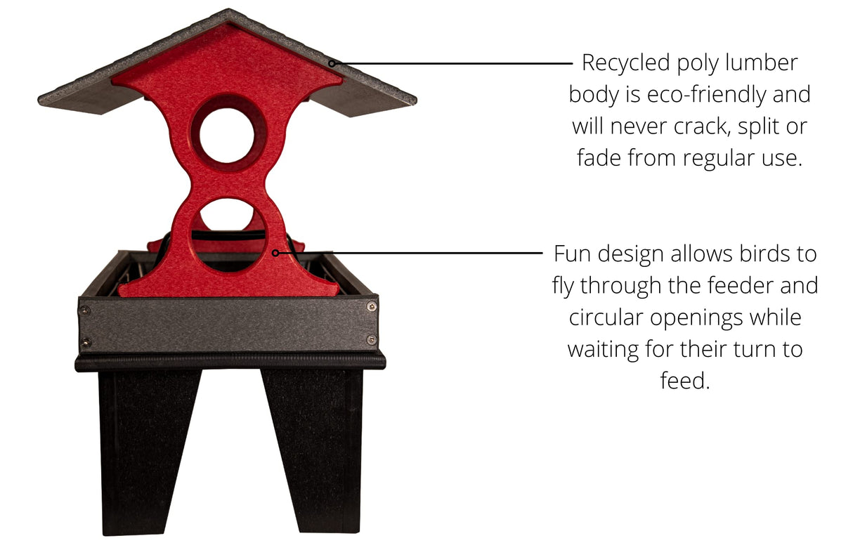 Product shot of a red and gray recycled poly lumber bird feeder with a pitched roof and two circular openings on a black stand